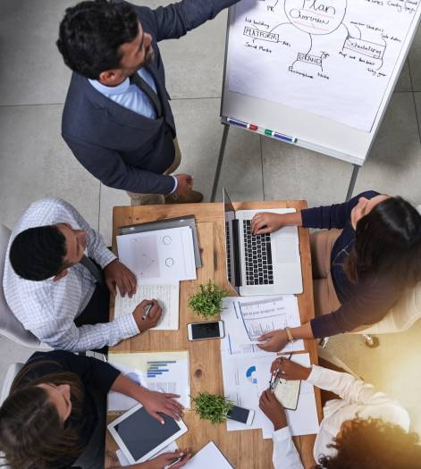 High angle shot of a group of businesspeople having a meeting around a table.